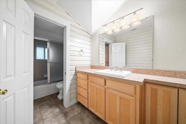 full bathroom featuring vanity, enclosed tub / shower combo, toilet, lofted ceiling, and wood walls