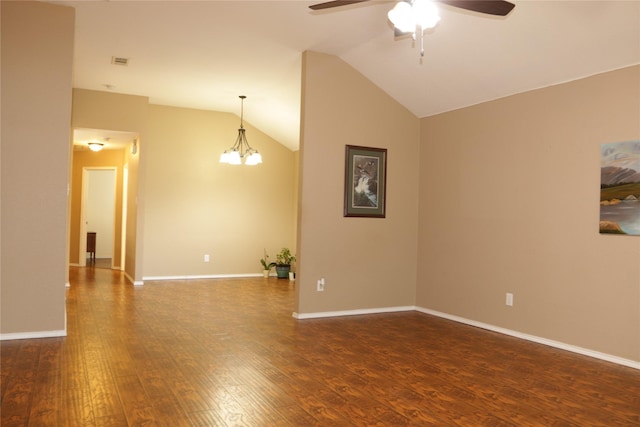 unfurnished room with vaulted ceiling, dark hardwood / wood-style floors, and ceiling fan with notable chandelier