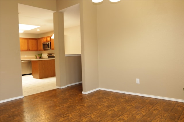 unfurnished room with hardwood / wood-style flooring