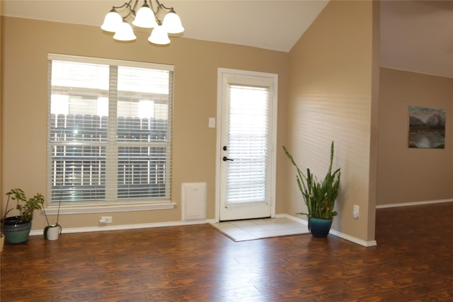 doorway with dark hardwood / wood-style floors, vaulted ceiling, and a notable chandelier