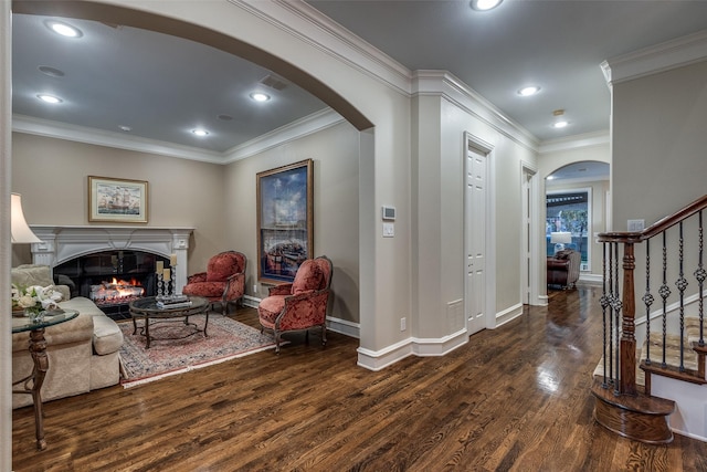 foyer featuring crown molding, a fireplace, and dark hardwood / wood-style floors