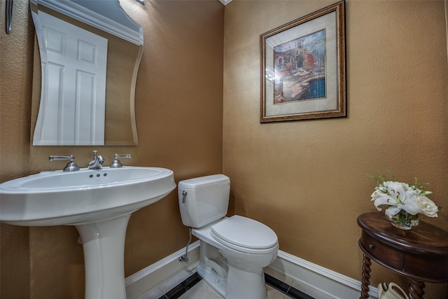 bathroom featuring tile patterned floors and toilet