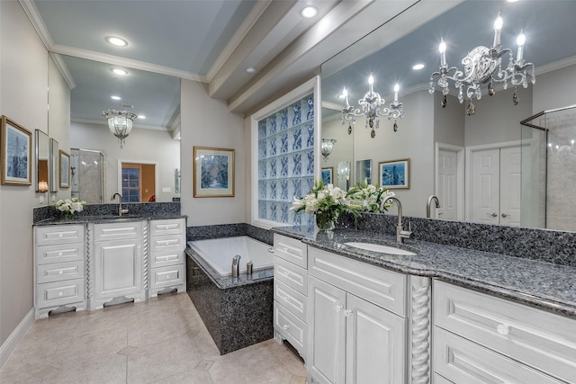 bathroom with plus walk in shower, a chandelier, tile patterned flooring, vanity, and crown molding