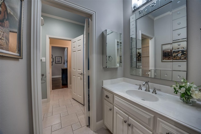 bathroom featuring crown molding and vanity