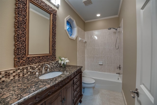 full bathroom with tile patterned flooring, vanity, ornamental molding, tiled shower / bath, and toilet