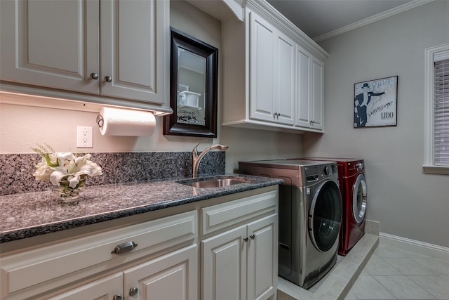 washroom with light tile patterned flooring, separate washer and dryer, sink, cabinets, and ornamental molding