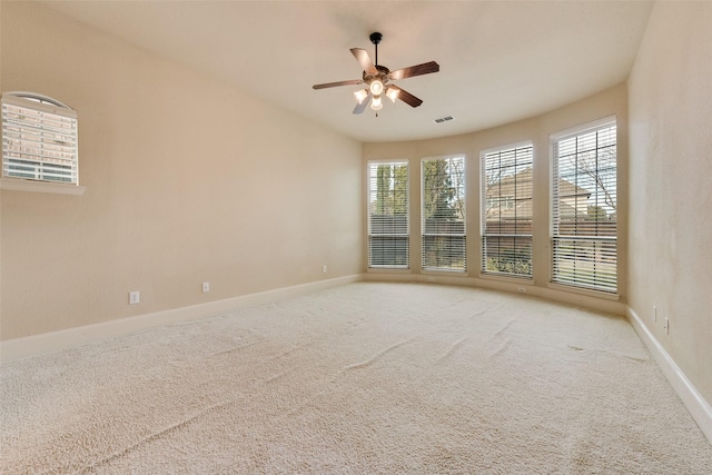 spare room featuring ceiling fan and light carpet