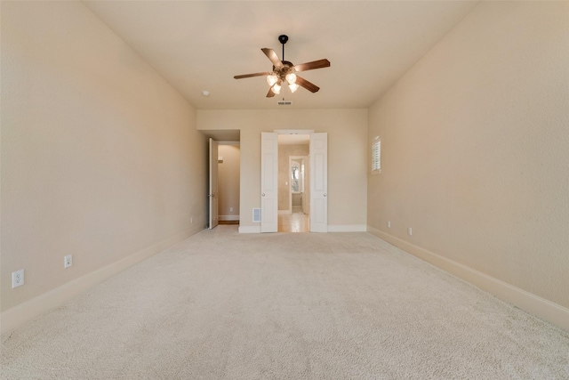 spare room featuring ceiling fan and light carpet