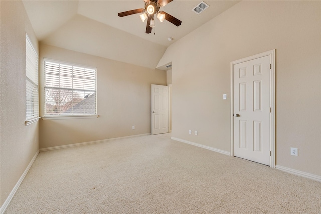 carpeted empty room with ceiling fan and lofted ceiling