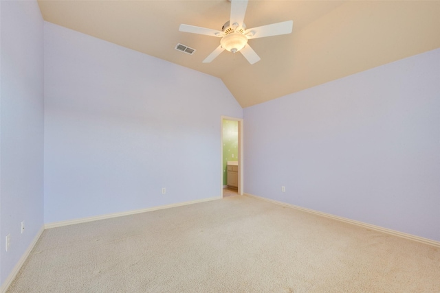 empty room with light colored carpet, ceiling fan, and lofted ceiling