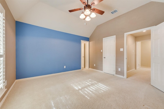 unfurnished bedroom featuring light carpet, vaulted ceiling, and ceiling fan