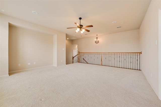 carpeted spare room with ceiling fan