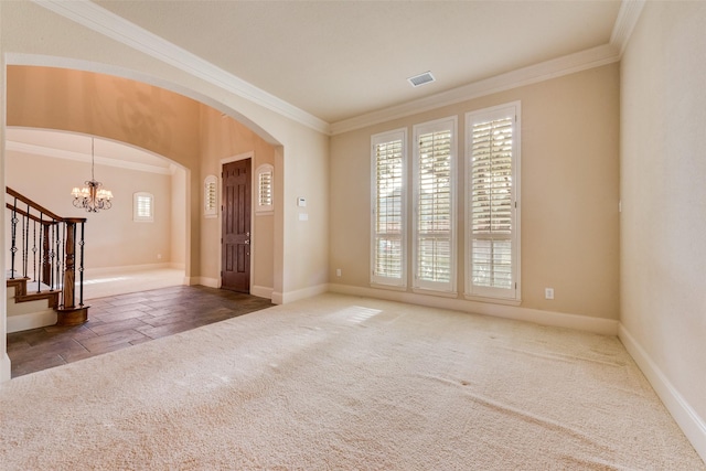 carpeted empty room with an inviting chandelier and crown molding