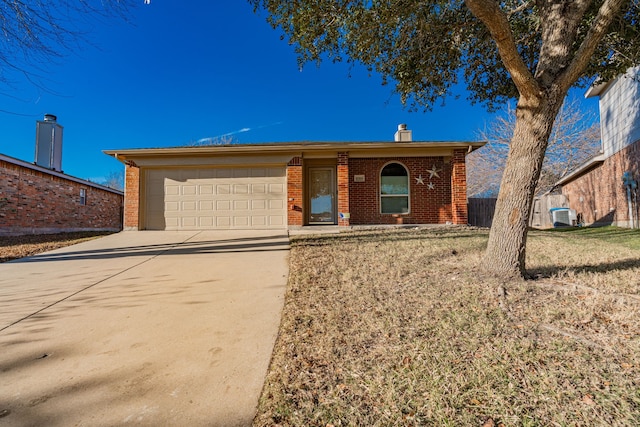 single story home with a garage and central air condition unit