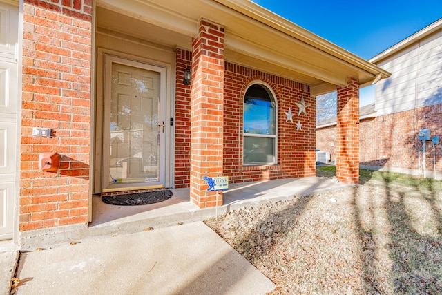 doorway to property with a porch and cooling unit