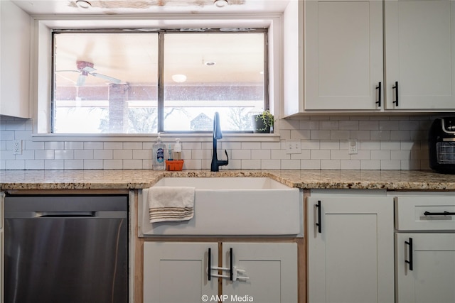 kitchen with sink, stainless steel dishwasher, tasteful backsplash, and white cabinetry