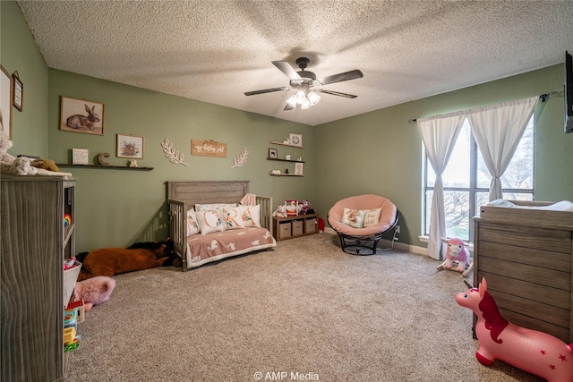 bedroom with a textured ceiling, ceiling fan, and carpet