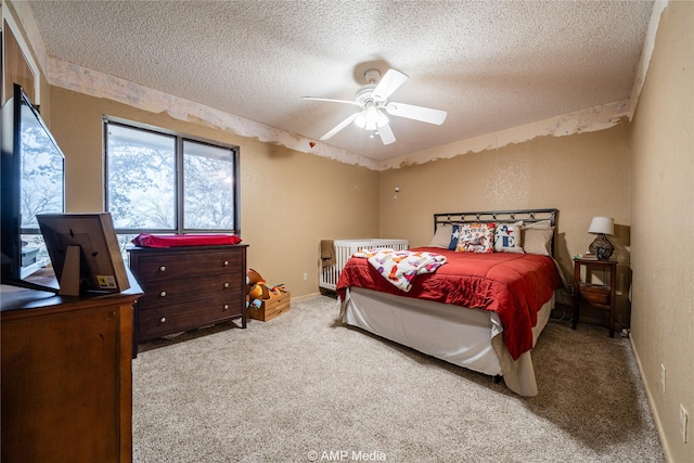 carpeted bedroom with a textured ceiling and ceiling fan