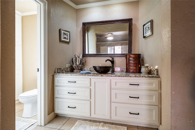 bathroom with toilet, ornamental molding, tile patterned floors, and vanity