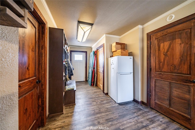 hall featuring a textured ceiling, dark wood-type flooring, and crown molding