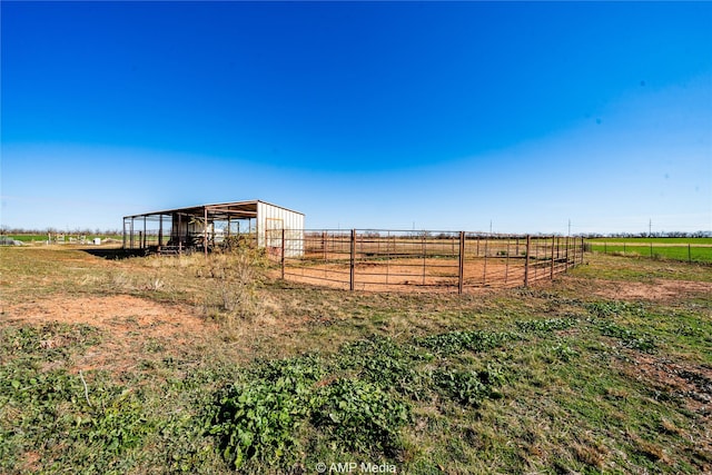 view of yard with an outbuilding and a rural view