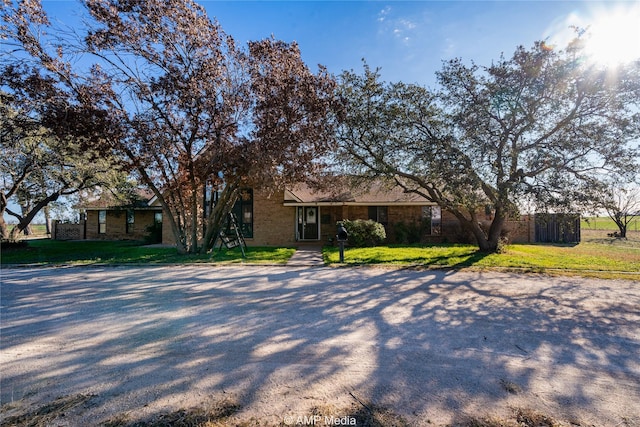 ranch-style home with a front lawn