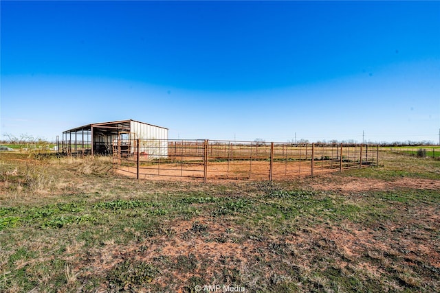 view of yard featuring an outbuilding and a rural view