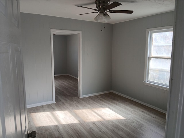 spare room featuring light hardwood / wood-style floors and ceiling fan