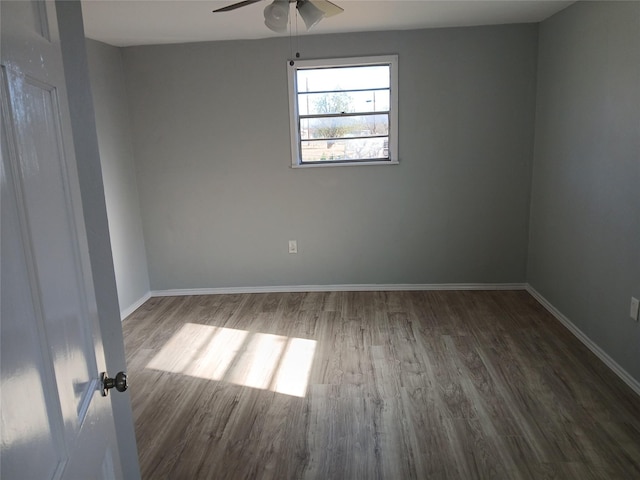 spare room featuring dark hardwood / wood-style floors and ceiling fan