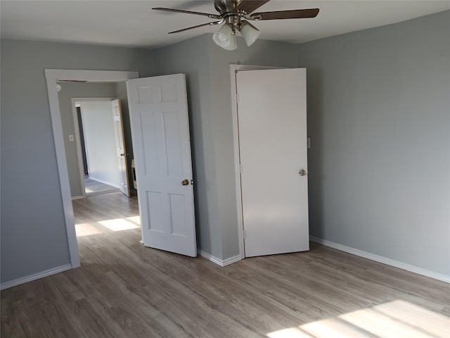 unfurnished bedroom with ceiling fan and light hardwood / wood-style floors