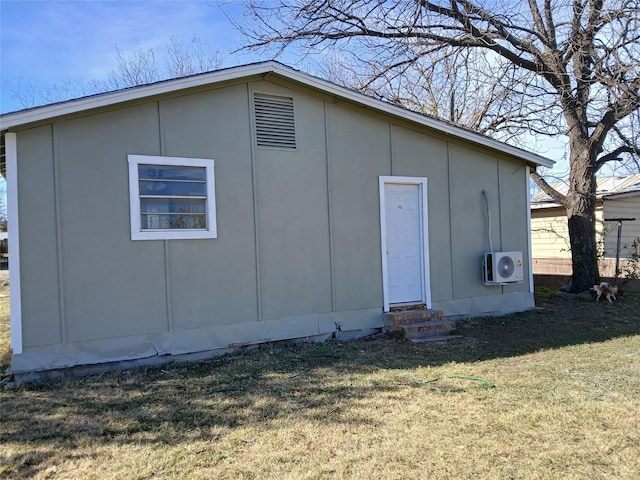 view of outbuilding with a lawn and ac unit