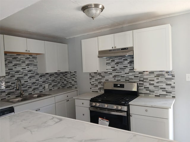 kitchen featuring backsplash, light stone counters, gas stove, sink, and white cabinets