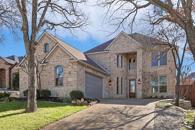 view of front of home with a front yard and a garage