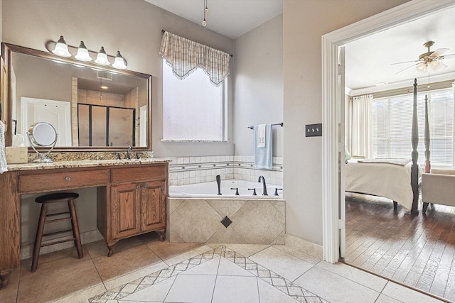 bathroom featuring ceiling fan, tile patterned flooring, vanity, and shower with separate bathtub