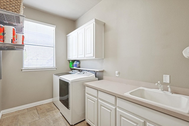 laundry area featuring sink, cabinets, and washing machine and clothes dryer