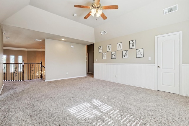 spare room featuring ceiling fan, crown molding, vaulted ceiling, and carpet floors