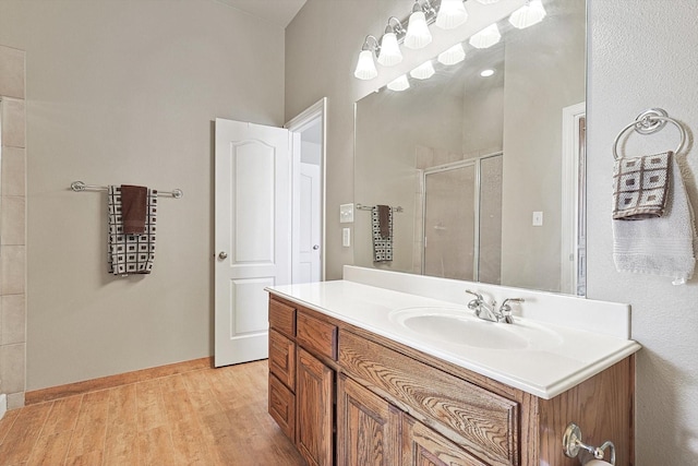 bathroom featuring vanity, walk in shower, and hardwood / wood-style floors