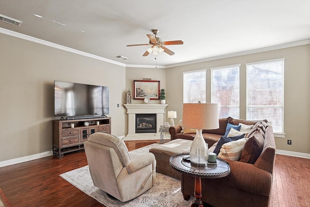 living room with ornamental molding, ceiling fan, and dark hardwood / wood-style floors