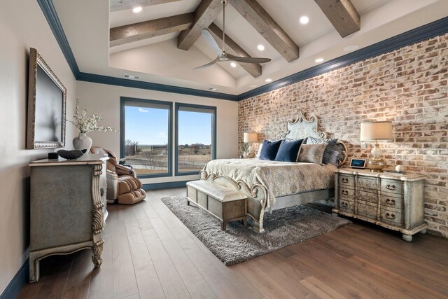 bedroom featuring brick wall, ceiling fan, lofted ceiling with beams, and hardwood / wood-style flooring