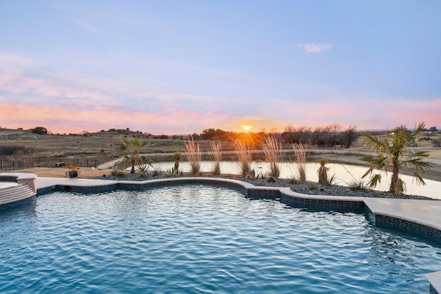 pool at dusk with a water view