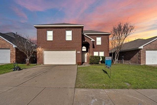 view of front property with a garage and a yard