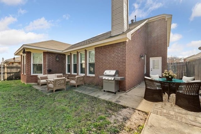 back of house with an outdoor living space, a yard, and a patio area