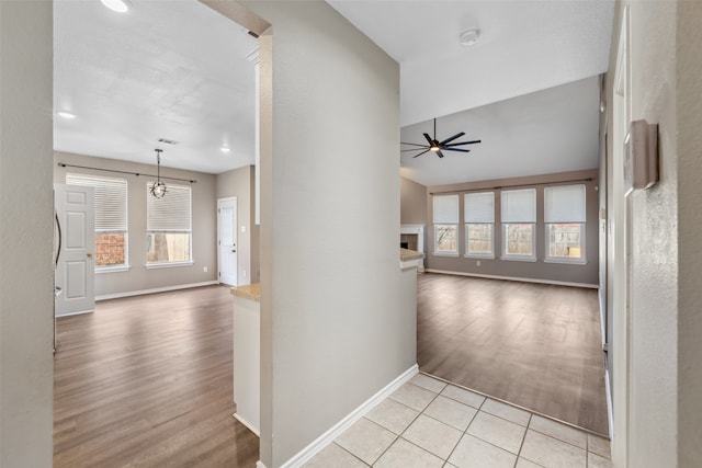 hallway with light hardwood / wood-style floors