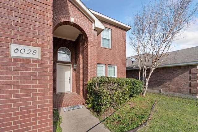 doorway to property with a yard