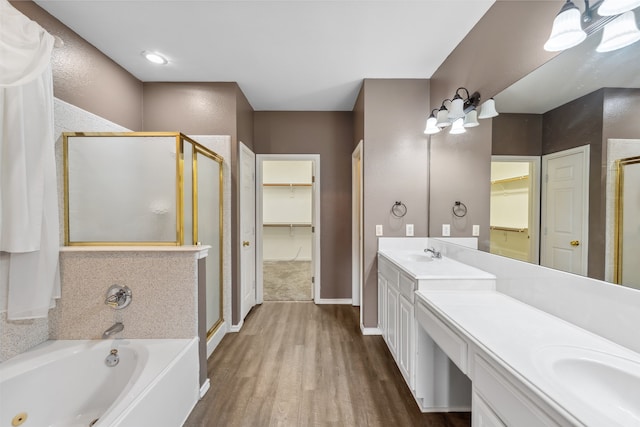 bathroom featuring vanity, independent shower and bath, and wood-type flooring