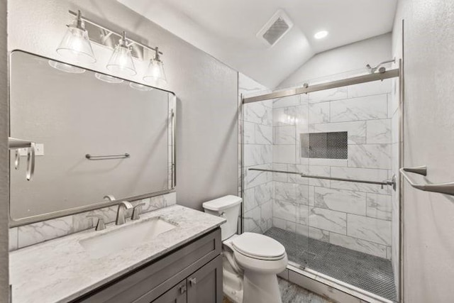 bathroom featuring lofted ceiling, vanity, toilet, and a shower with door