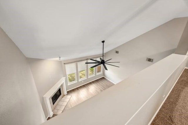 living room with ceiling fan, wood-type flooring, and vaulted ceiling