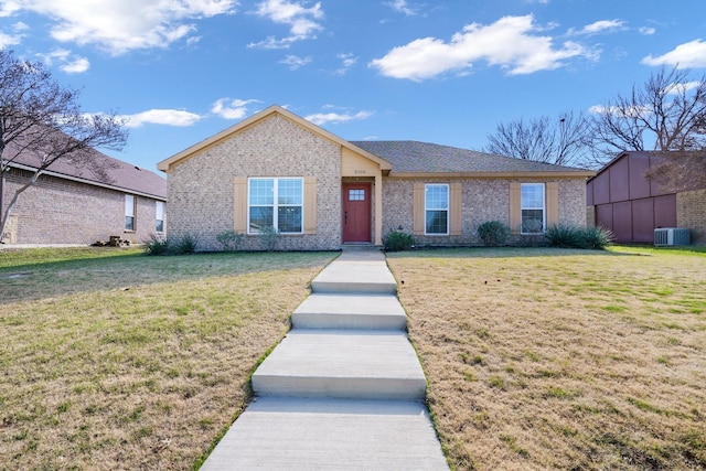 view of front of property featuring central AC and a front yard