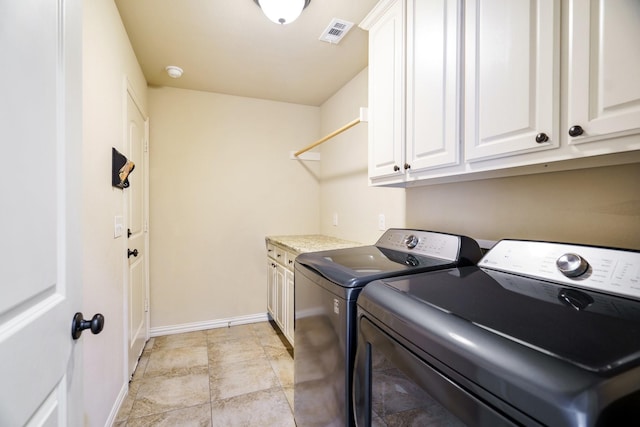 laundry area featuring cabinets and washing machine and dryer