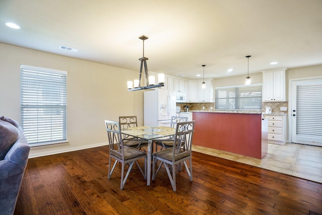 dining space featuring wood-type flooring